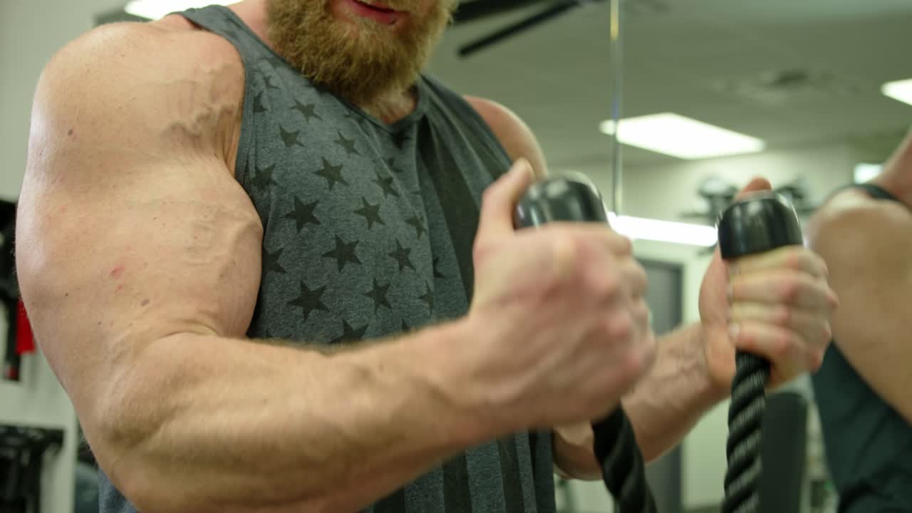 Young Adult Man Strenuously Working Out at Gym