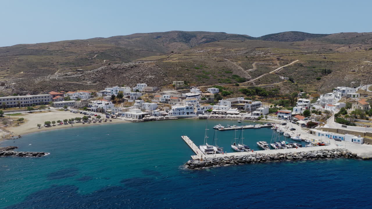 Loutra traditional seaside village and a port in Kythnos island, Cyclades, Aerial tracking shot