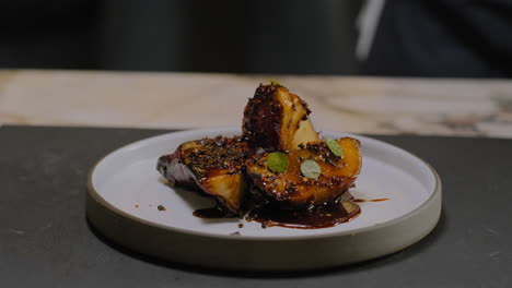 slow motion shot of a chef plating a gourmet sweet potato dish in a restaurant