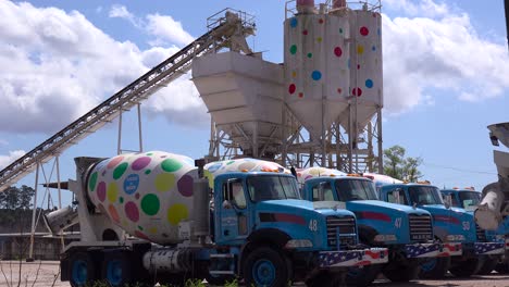 trucks and cement towers are decorated with polkadots at this artistic business