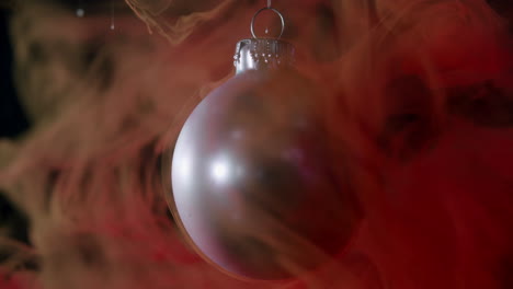 silver xmas bauble in red moving liquid