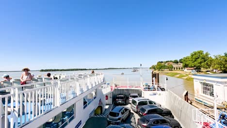 vehicles on ferry crossing river in blaye