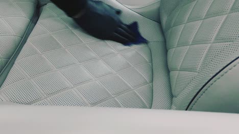 cleaning a white leather chair in car