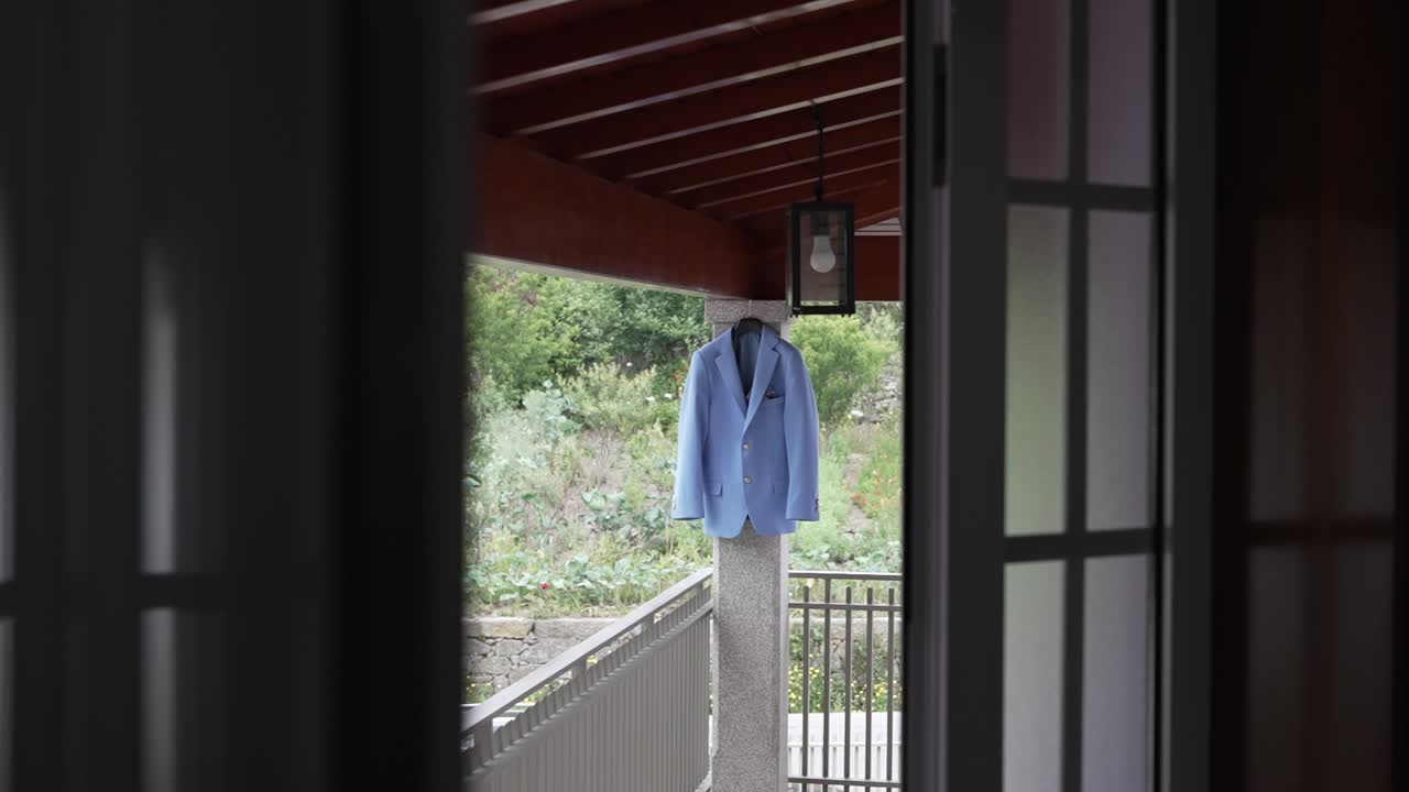 Light blue groom suit jacket prepared for wedding day