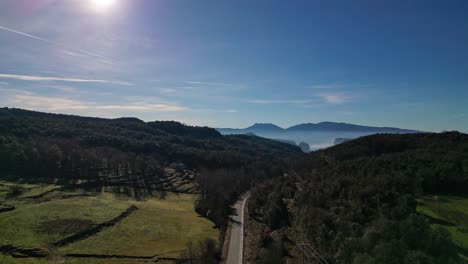 A-breathtaking-aerial-view-of-the-lush-Tavertet-region-in-Barcelona-with-a-distant-mountain-range