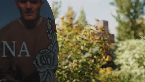 man visits grave and places flowers