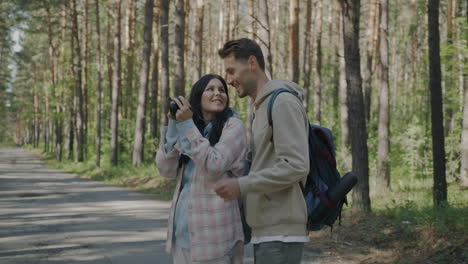 couple taking pictures in a forest