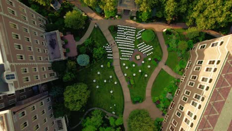 top-down-of-ceremony-high-end-wedding-white-chairs-without-guests-sorrounded-by-high-structures