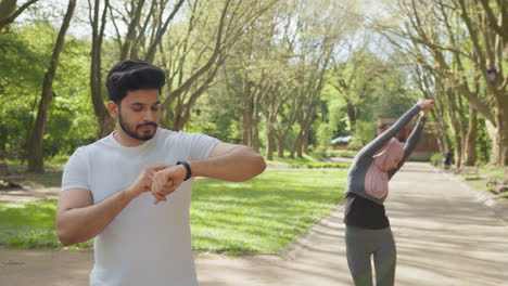 couple exercising in a park