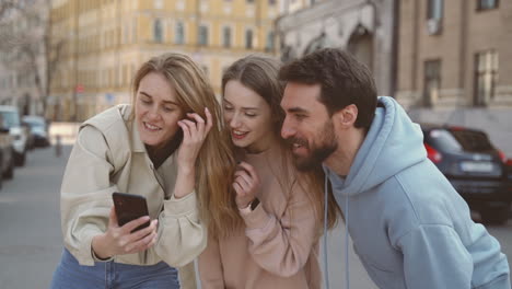 a group of three young friends taking a funny selfie