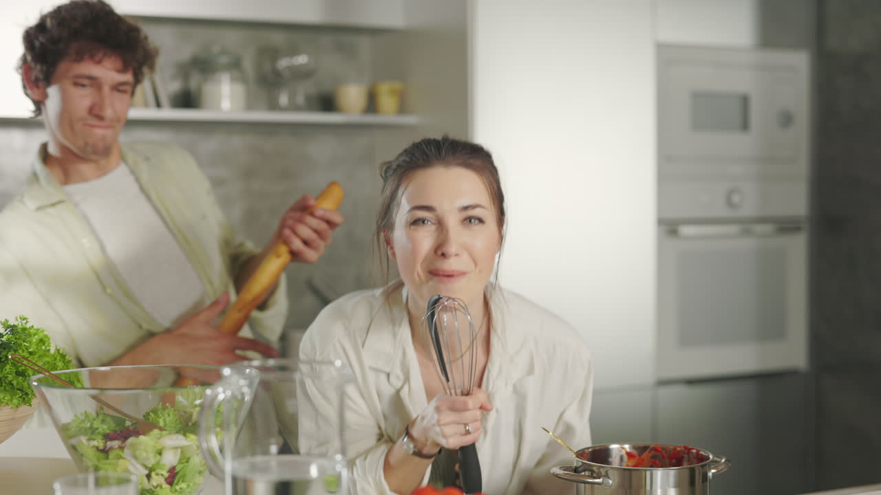 Happy Couple Singing and Dancing in the Kitchen