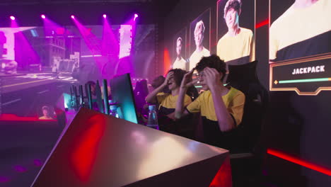 cyber sportsmen hugging and celebrating victory team of young esportsman gamers players screaming and embracing each other while celebrating victory in gaming tournament cybersport