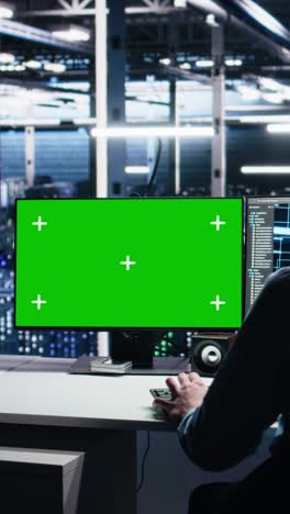 vertical video data center engineer using machine learning algorithms on green screen pc
