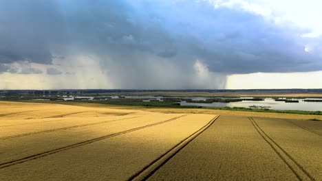 Aerial-shot-of-a-farm-field-with-a-storm-in-distance