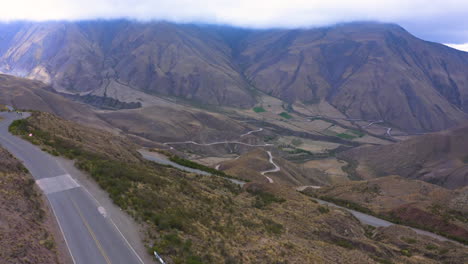 aerial - cuesta del obispo hills and valley in salta, argentina, rising tilt down