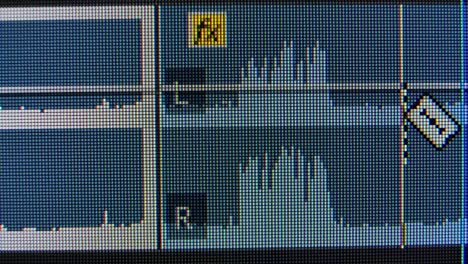 audio editing waves on a computer screen. macro liquid crystal structure ips matrix with red, blue and green glowing crystals and graphic patterns of the computer's graphic monitor