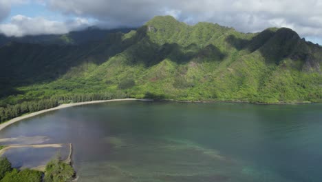 flying over beautiful crouching lion hike with panoramic aerial view of kahana valley and bay, hawaii