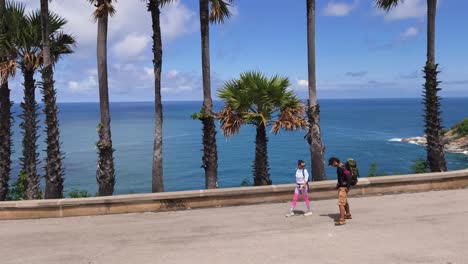 people walking along a scenic ocean viewpoint