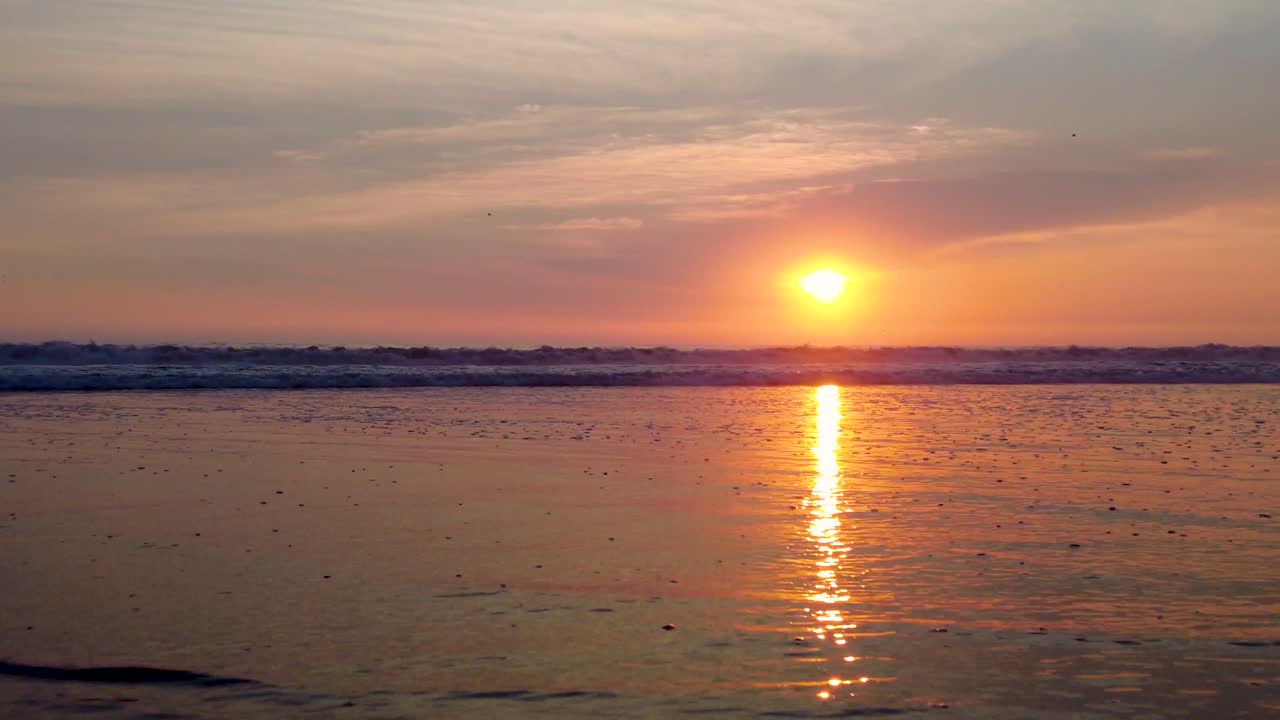 sunset at the beach, ocean waves and sand, no people
