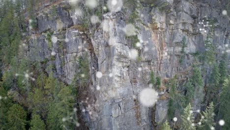 digital composition of molecular structures floating against aerial view of the mountain