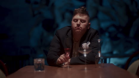 man in a suit enjoying wine in a restaurant