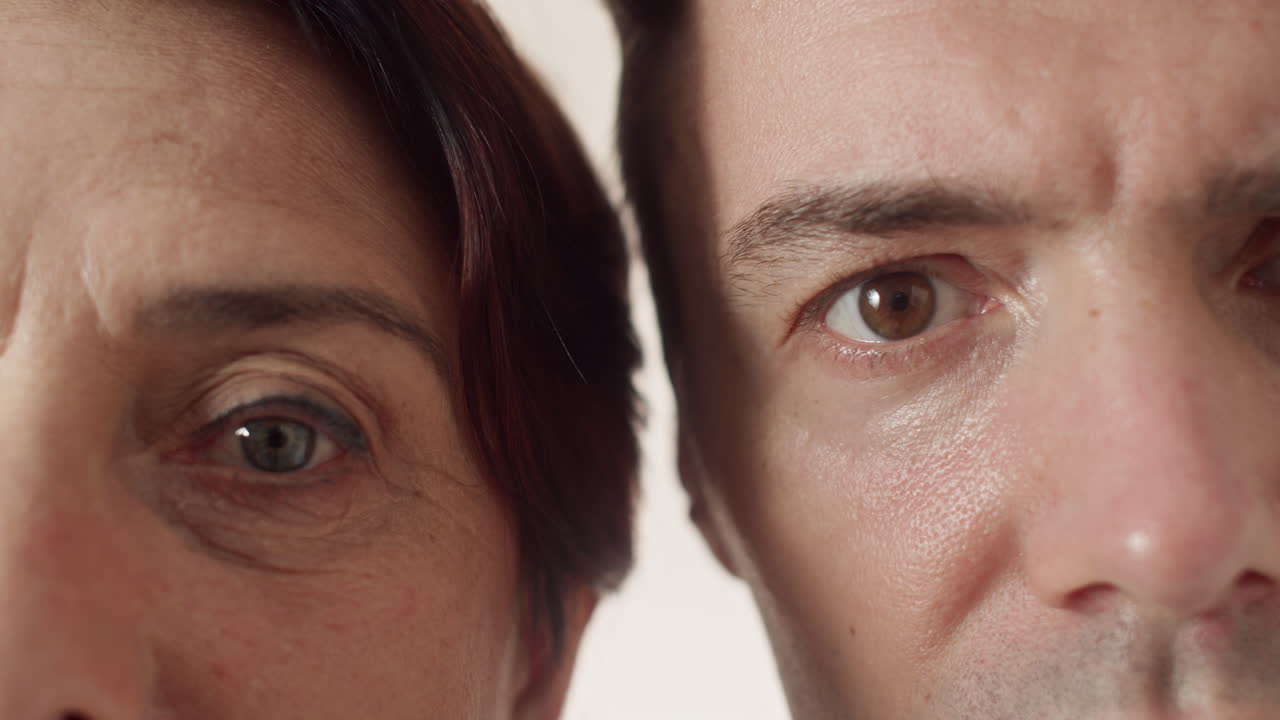 Mature Woman and Man with Blue and Brown Eyes Looking at Camera