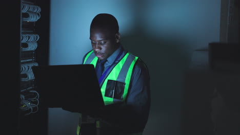 black man, laptop and control room