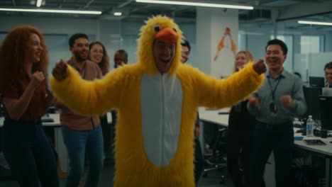 a joyful office celebration: employees laughing and dancing around a colleague dressed in a bright yellow duck costume, creating a fun and engaging work environment