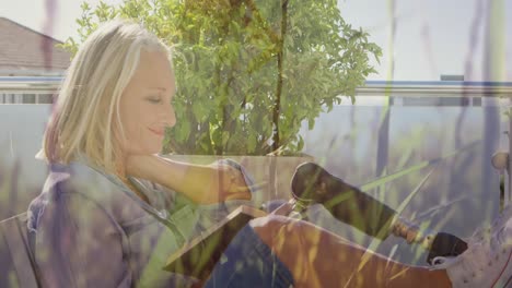 animation of grass over disabled caucasian woman with artificial leg