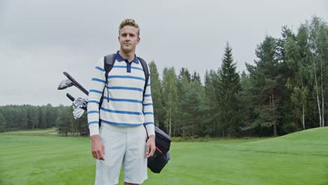 man with golf clubs on golf course