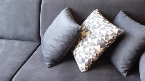 gray couch with patterned pillows