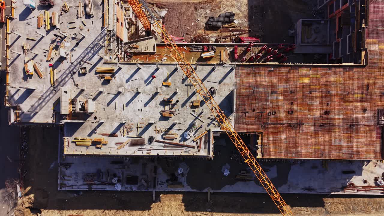 Aerial Top-Down View of Construction Site with Moving Crane