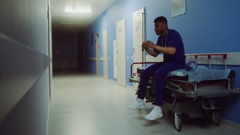 stressed doctor in hospital corridor