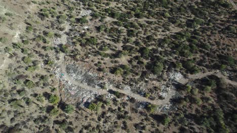 A-View-of-Garbage-Tarnishing-the-Desert-Landscape-of-Mulege,-Baja-California-Sur,-Mexico---Drone-Flying-Forward