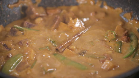 vegetarian rich, creamy and flavorful thai massaman curry with spices cooking in a pot