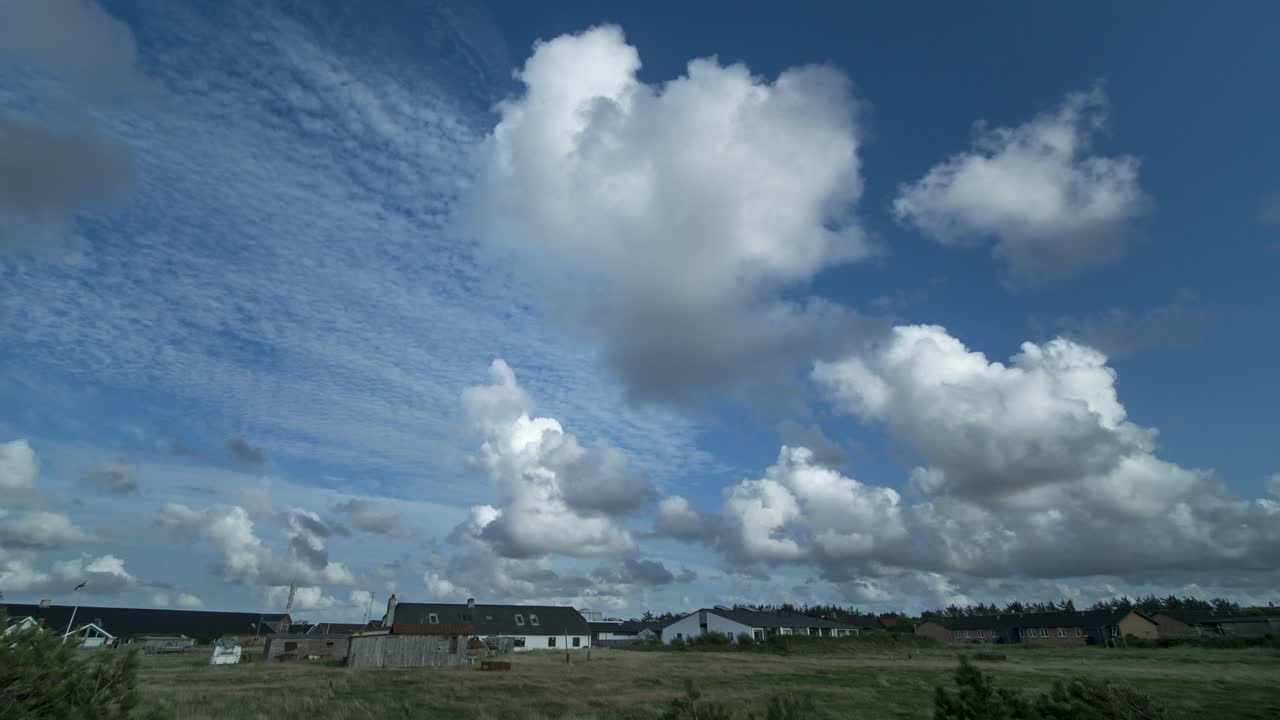 전경에 풀과 나무가 있는 집 위로 푸른 하늘에서 움직이는 구름의 시간 경과