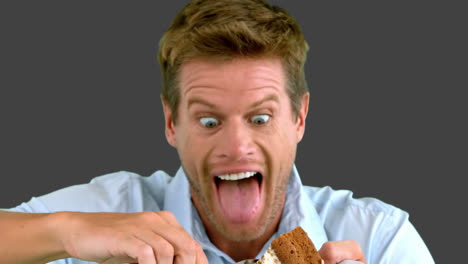 hombre atractivo a punto de comer un pastel en la pantalla gris