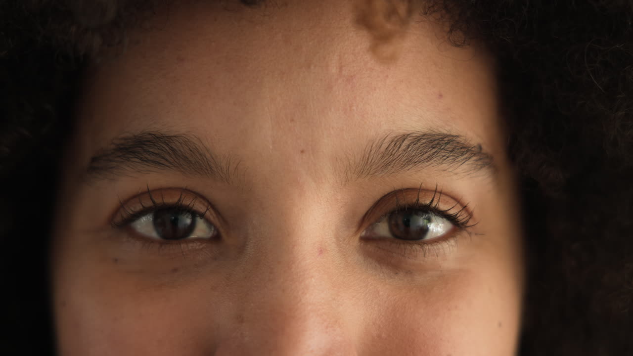 Expressing curiosity and contemplation, close-up of woman's eyes in focus, at home