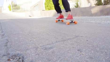 young man in red sneakers skating in the street