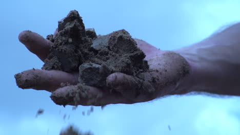 Dirty-Hand-With-Soil-And-Gravel-Stones-On-Palm-Falling