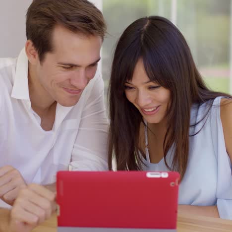 pareja sonrojada mostrando imágenes de ultrasonido
