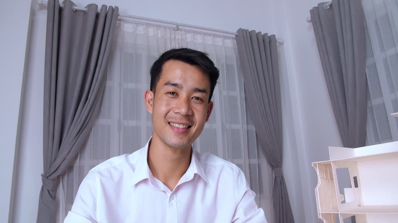 Young Asian Architect Smiling And Looking At Camera