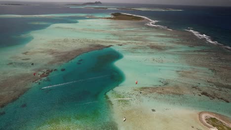 kite surfers at cayo vapor in los roques, vibrant sea tones, aerial view