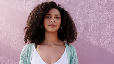 Portrait-of-a-happy-woman-touching-her-afro