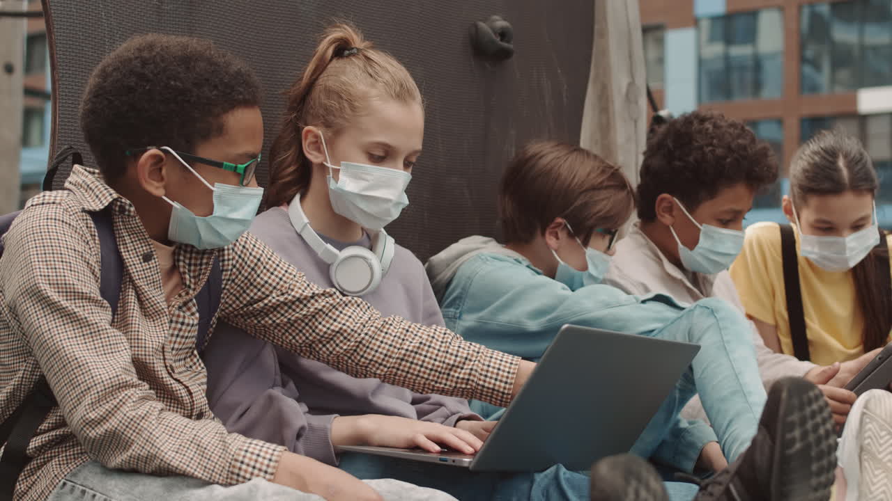 School Kids in Face Masks with Gadgets Outdoors