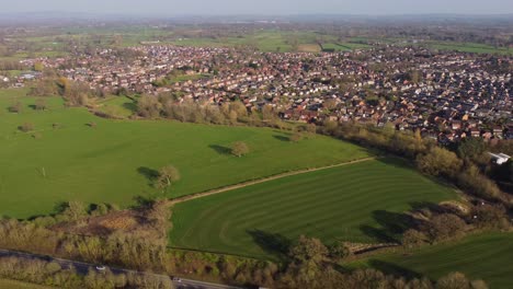 drone retreating from haslington village to reveal countryside and a534 road - crewe, cheshire, uk
