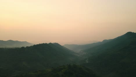 Drone-video-view-of-mountains-peaks-with-fog-and-sunlight