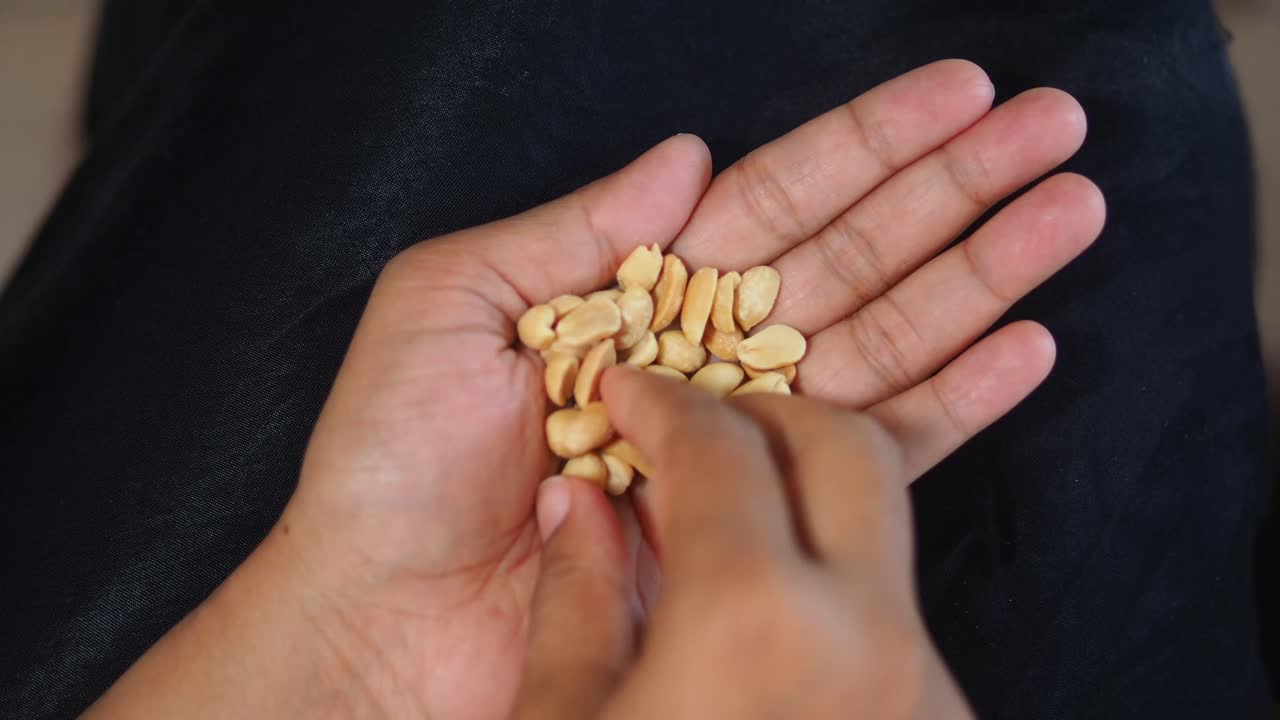 Hand holding peanuts