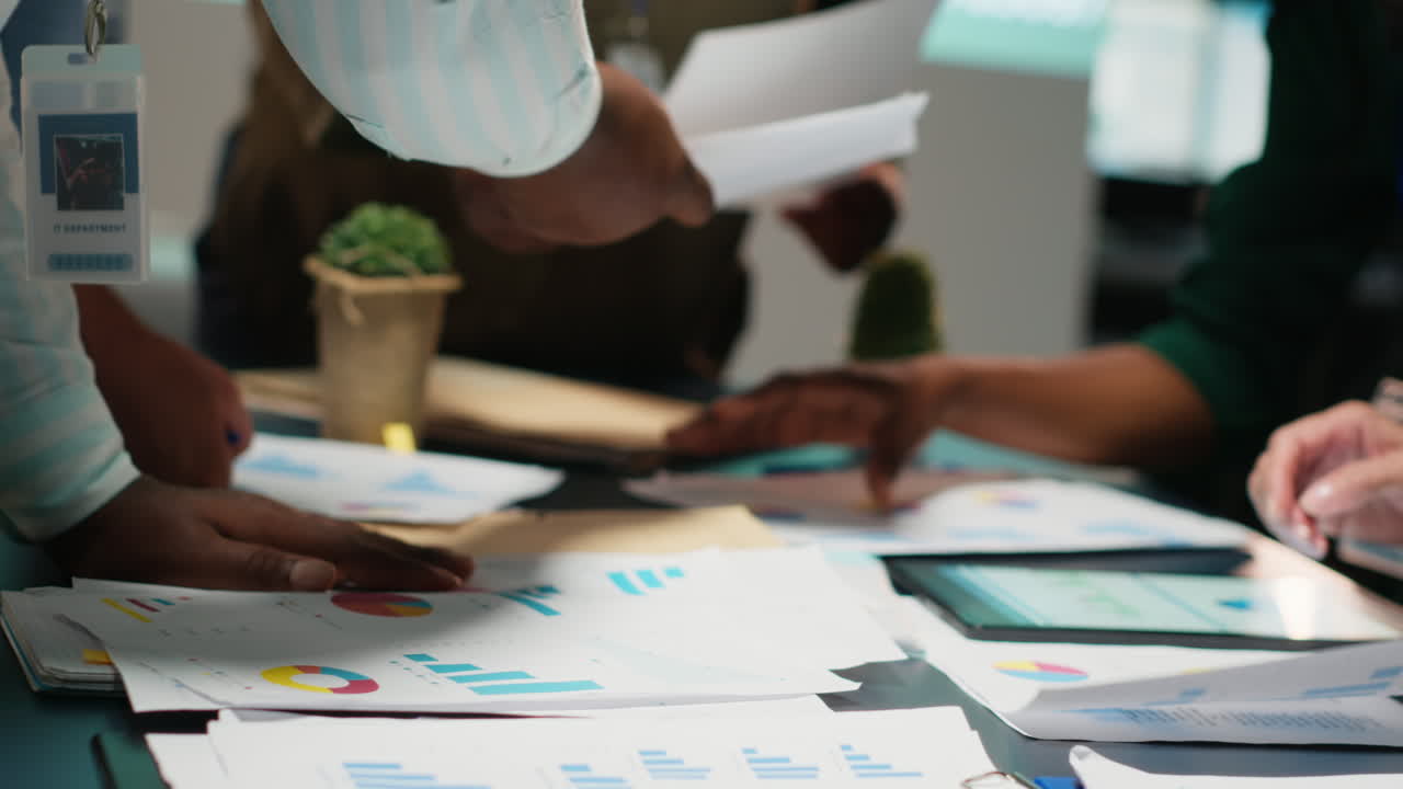 Business consultants team meeting after hours to review diagrams