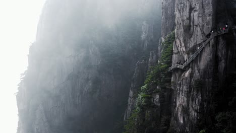breathtaking hike on cliffside path through misty mountains